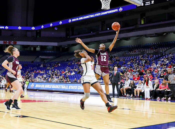 Chrishawn Coleman attempts a fast break layup over Frisco Liberty's Jacy Abii in the Class 5A UIL state girls basketball championship on Saturday at the Alamodome.